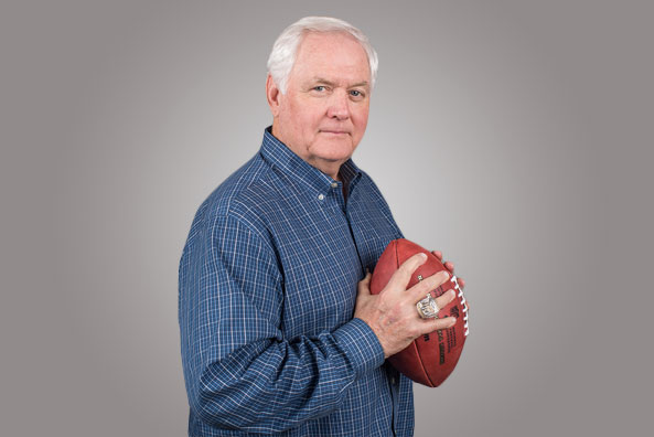 A man holding a football in his hands.